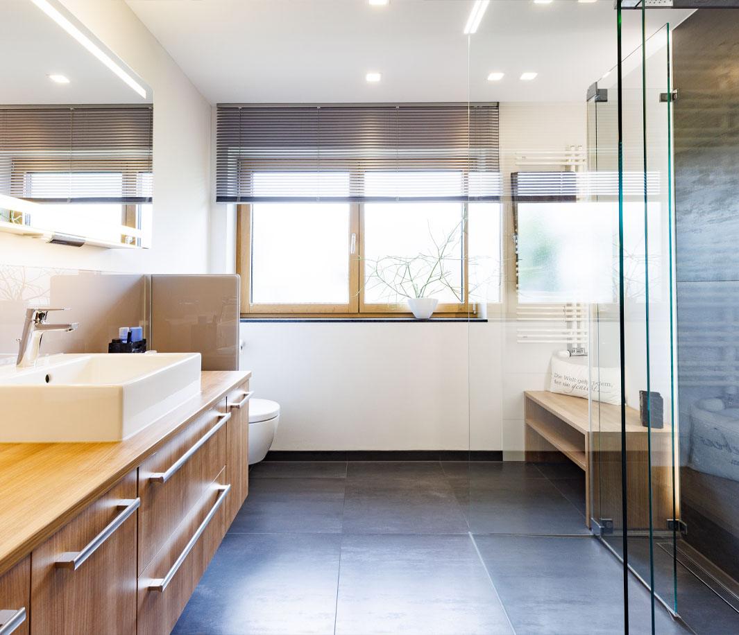 Modernes Badezimmer mit Walk-In-Dusche und Badmöbeln in Holzoptik